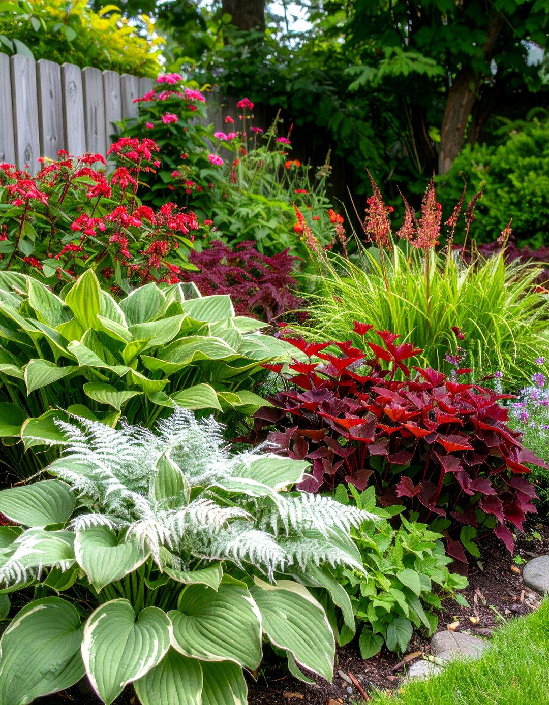 A Flower Bed with Bold Foliage - 30 front yard flower bed ideas