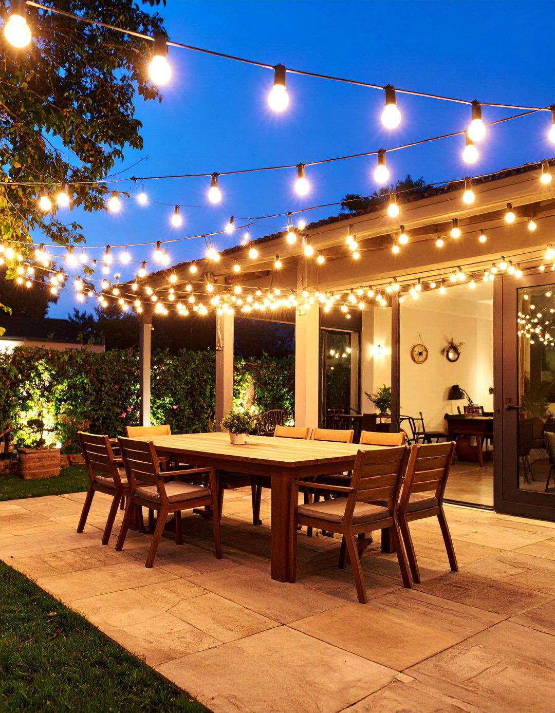 A String Light Canopy Dining Area - 30 backyard ideas on a budget