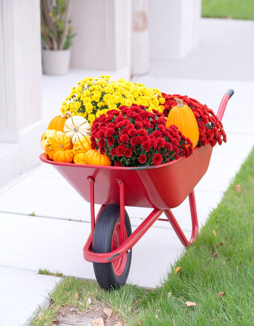 A Wheelbarrow Overflowing with Mums and Gourds - 30 outdoor fall decor ideas