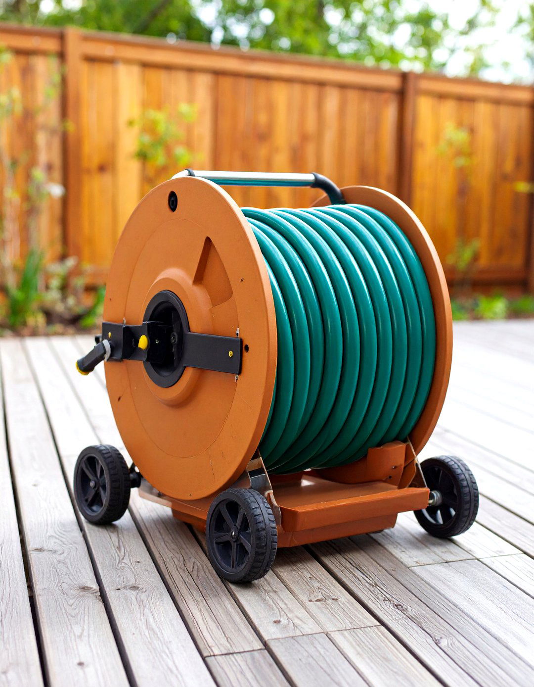 The Hidden Hose Reel Pot Planter - 30 garden tool storage ideas