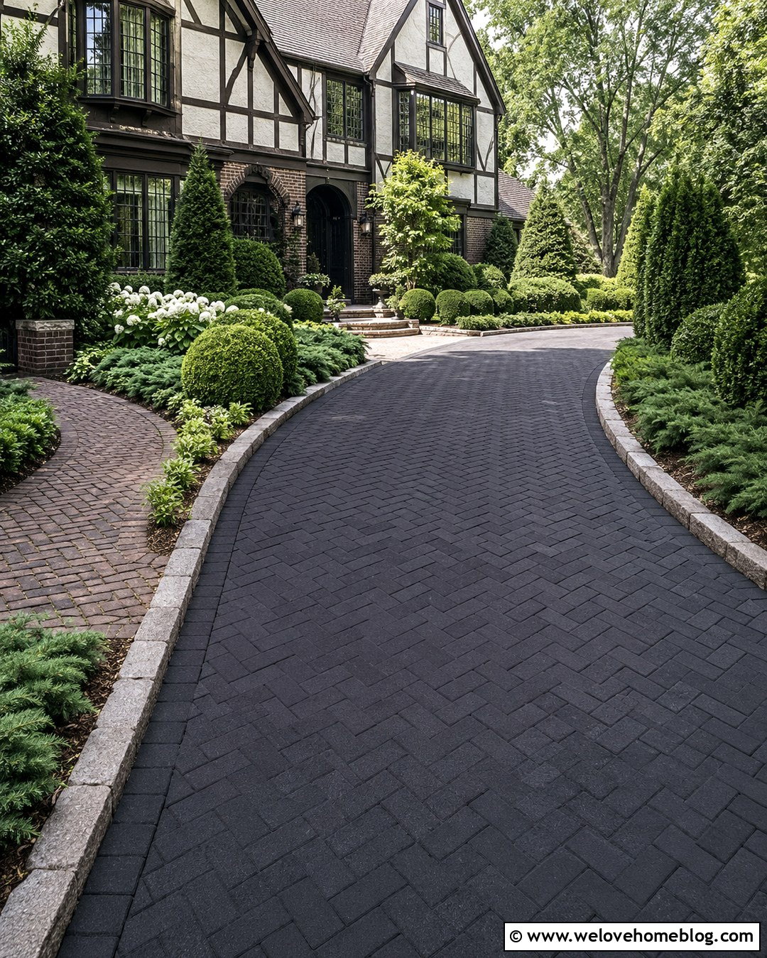 Black Brick Driveway With Evergreen Borders
