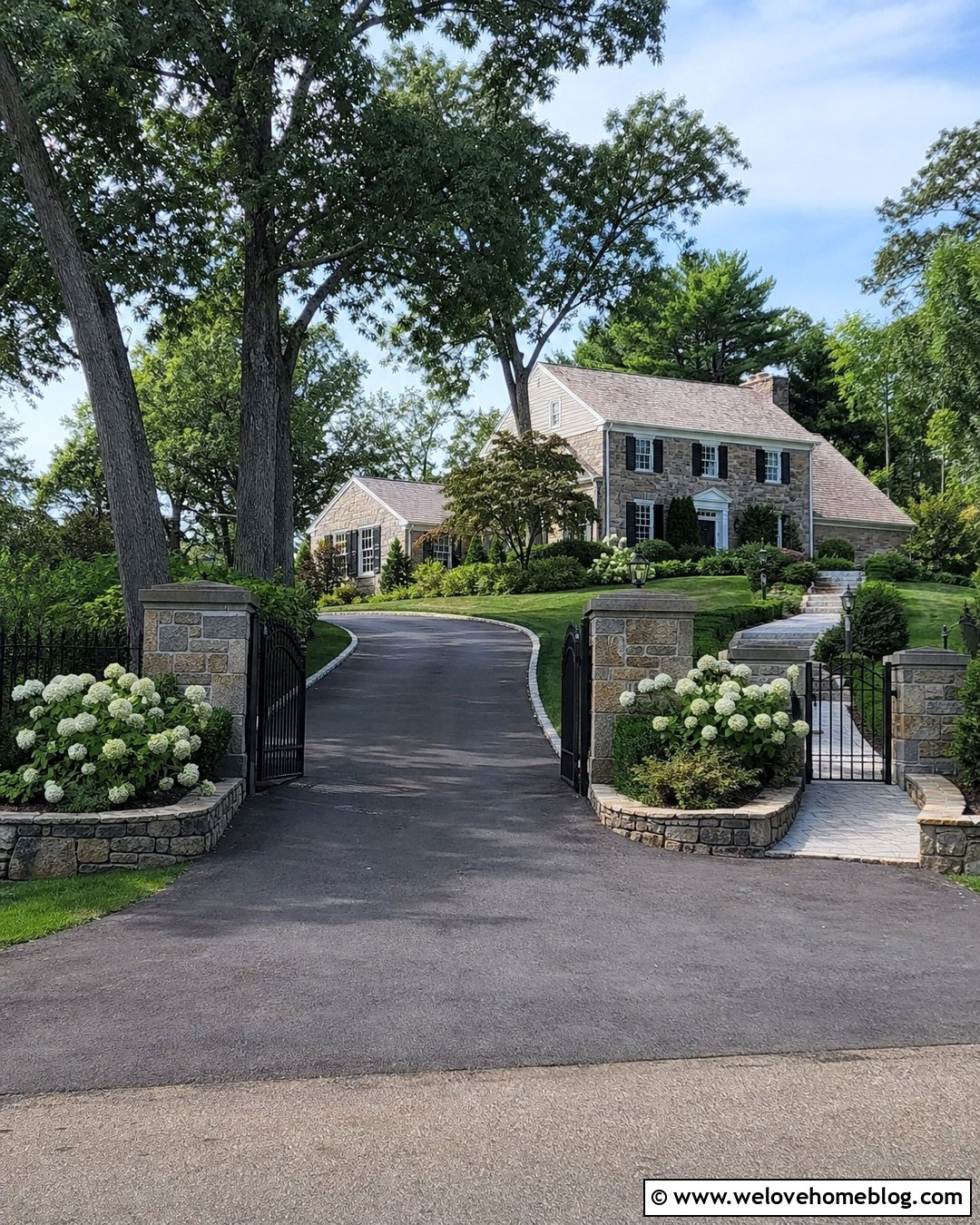 Dark Grey Stained Concrete Driveway With Gate And Stone Pillars - 20 grey stained concrete driveway ideas