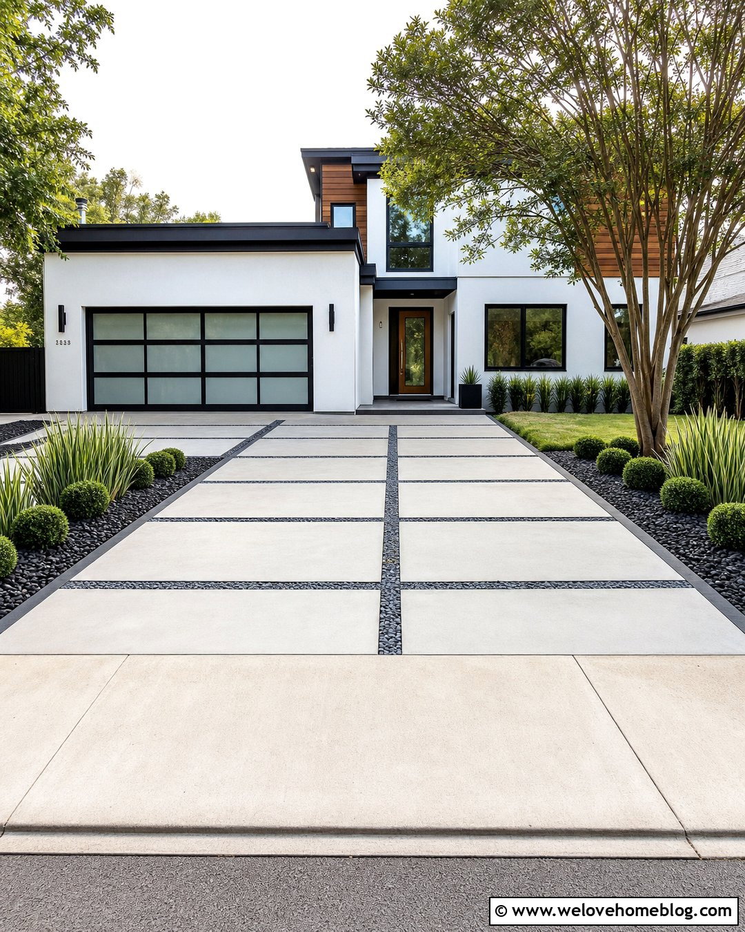 Modern Concrete Driveway With Black River Rock - 20 river rock along driveway ideas