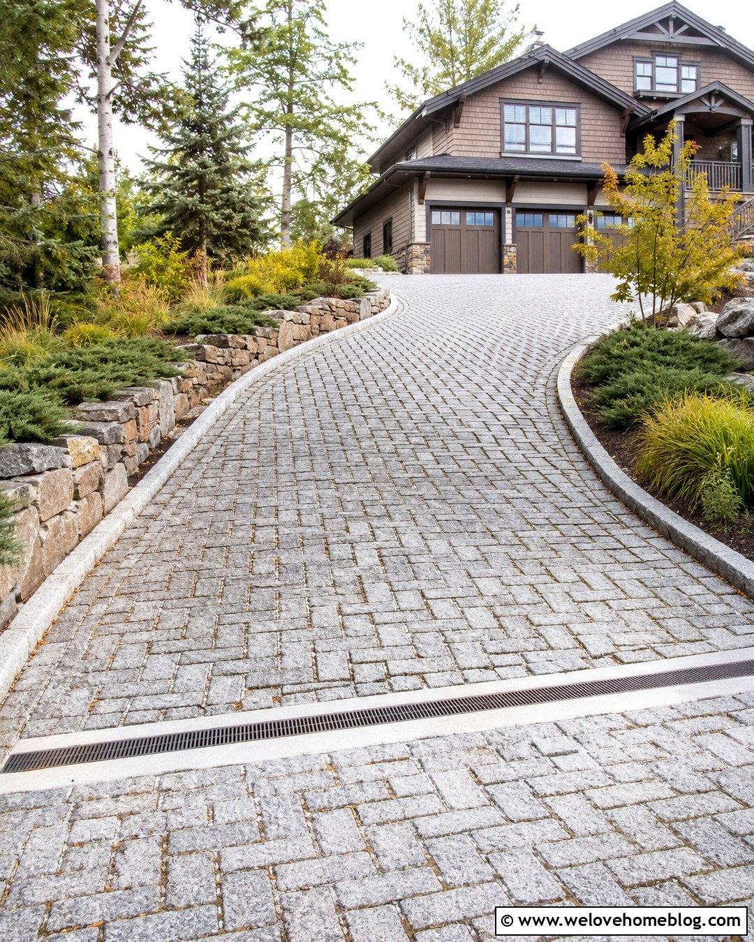 Sloped Grey Cobblestone Driveway With Stone Walls - 20 Grey Cobblestone Driveway Ideas