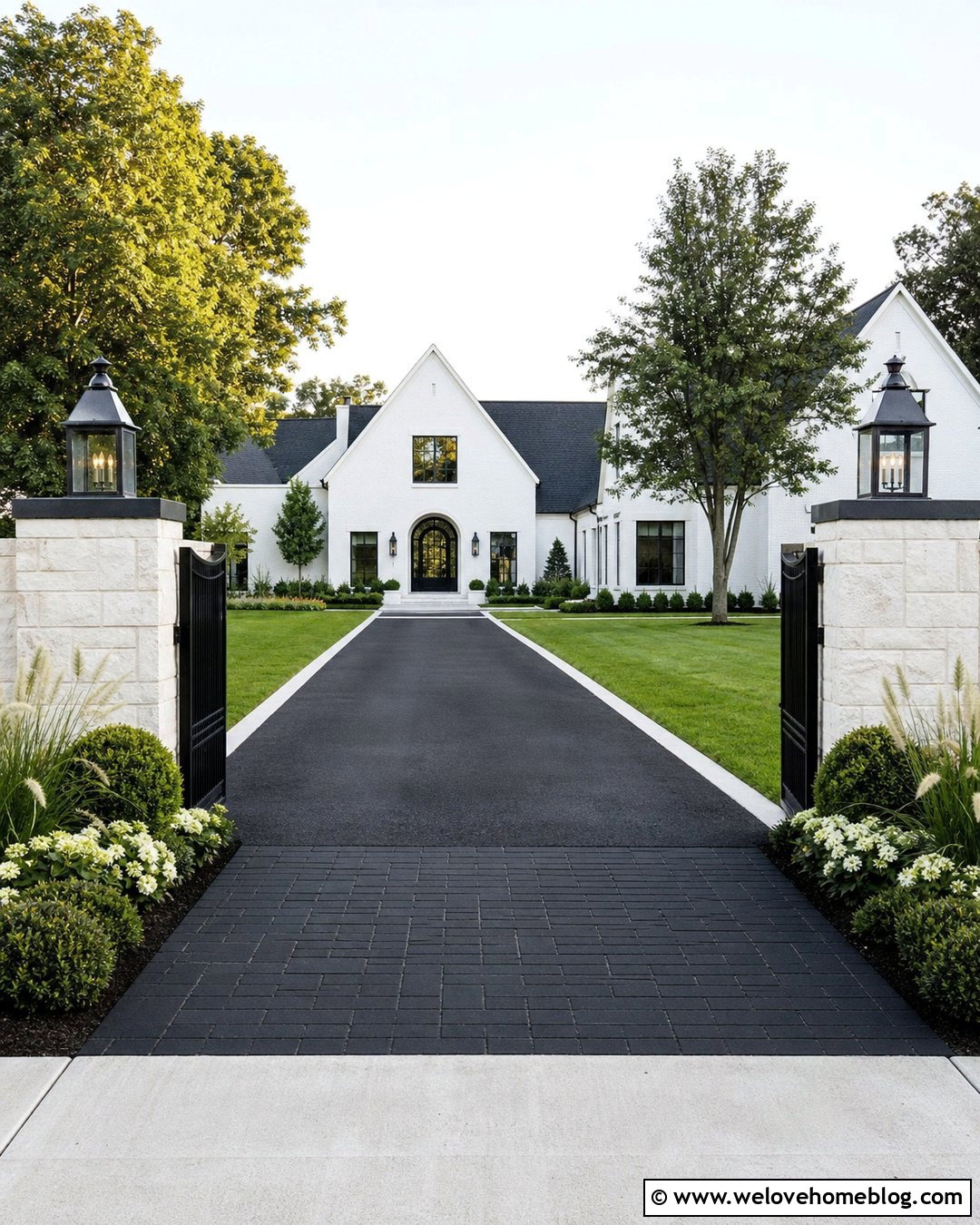 White Stone Pillars With A Dark Driveway - 40 Stone Pillars Driveway Entrance Ideas